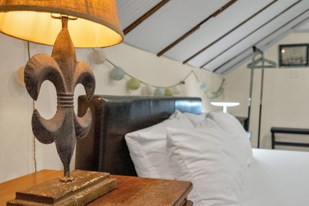 Plush bed w/ soft linens & elegant headboard for a truly restful night.