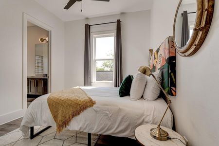 Bright upstairs bedroom w/ large window, natural light & a welcoming feel.