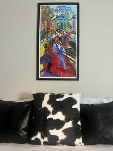 Vibrant local artwork sets the mood in this stylishly decorated bedroom.