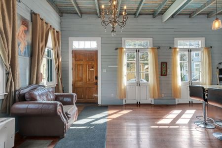 Sun-drenched entry w/ classic wood accents & a warm, welcoming vibe.