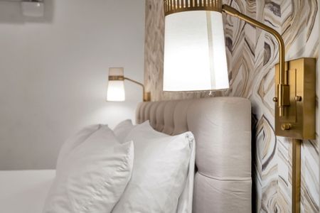 Plush pillows & warm bedside light set the tone for a good night's sleep.