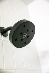 Sleek shower head for a refreshing rinse after a full day of exploring the city.