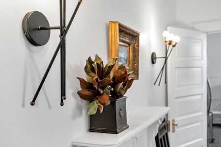 Decorative console w/ a mirror & artful accents that add personality to the space.