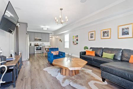 Open-concept front room blending kitchen & living space seamlessly.
