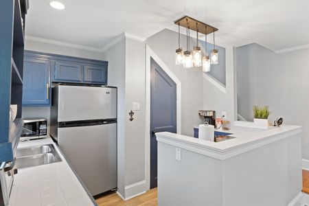 Fully stocked kitchen w/ fridge & bright, functional layout.
