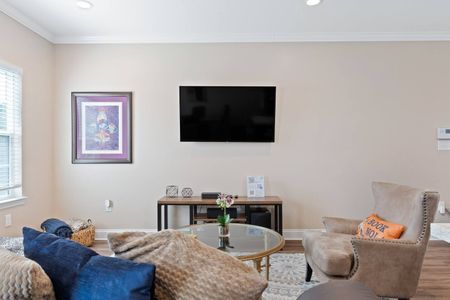 Living room w/ wall-mounted TV — perfect for a quiet evening in.