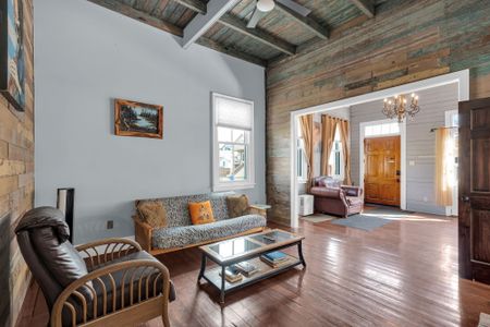 Bright, open living area flooded w/ natural light & warm wood floors.
