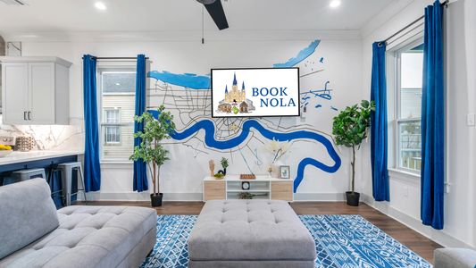 Living room adorned w/ a colorful NOLA map mural that sets the local vibe.