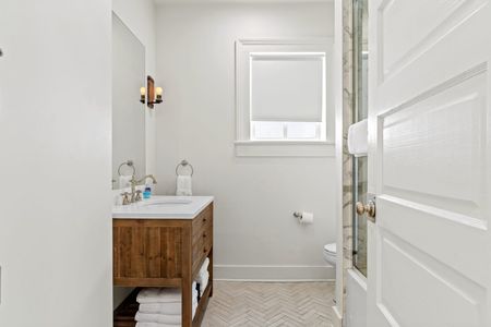 First bathroom w/ a spacious shower & large mirror.