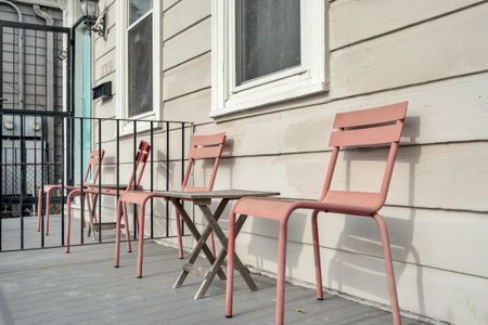 Charming front porch w/ seating — your go-to spot for a slow morning coffee.