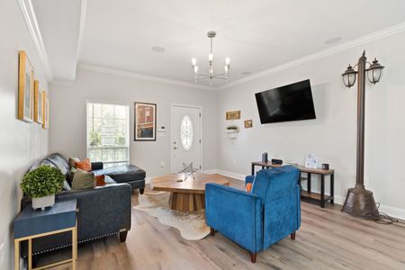 New Orleans-inspired living room w/ bold blue accents & TV for all your streaming needs.