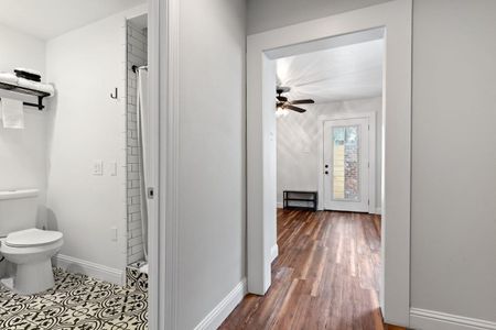 Bright hallway leading to a full bathroom — clean & easy to navigate.