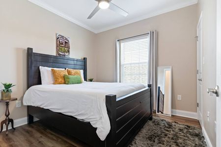 Cozy queen bedroom w/ warm tones & soft bedding for a restful night's sleep.
