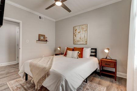 Cozy bedroom w/ warm tones & soft bedding for a good night's rest.