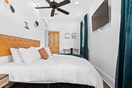 Airy bedroom 2 viewed from the balcony door — bright, open & easy to unwind in.