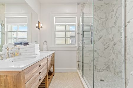 Clean bathroom w/ shower & vanity.