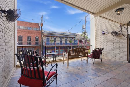 Balcony seating w/ open-air views of the surrounding neighborhood