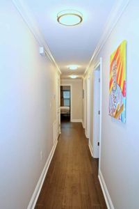 Colorful hallway w/ artistic murals adding a local, creative touch.