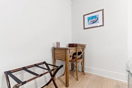 Bedroom nook w/ a wood desk — ideal for a quiet work-from-home moment.