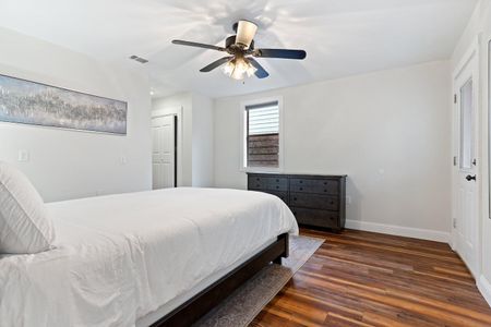 Bright queen bedroom w/ a ceiling fan & natural light for cool, easy nights.
