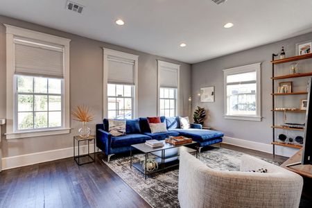 Bright, airy living room w/ plush blue sofa — perfect for the whole group to kick back & relax.