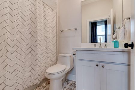 Clean, bright bathroom w/ a sink, toilet & tub — everything you need.
