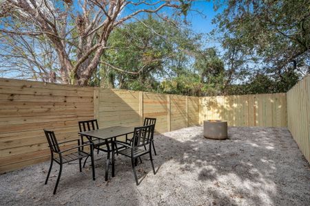 Shaded outdoor dining area surrounded by lush trees — perfect for al fresco meals.