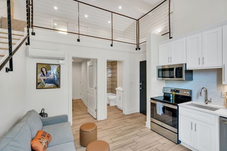 Relax in the inviting living room, complete with cozy seating and a flat-screen TV, offering a comfortable space to unwind during your stay