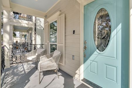 Bright entryway w/ bold teal door & stylish full-length mirror.