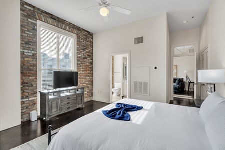 Bedroom w/ en suite access & a cozy TV setup for winding down.