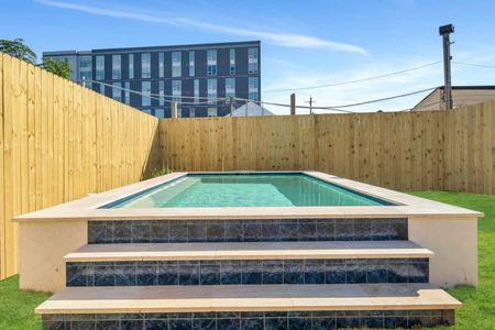 Sun-soaked pool tucked behind a tall wood fence — your own private escape.