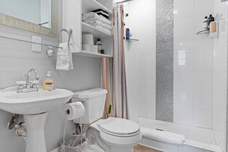 First floor full bathroom w/ sink & clean, neutral finishes.