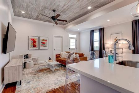 Bright, airy living room w/ warm tones & stylish decor to unwind after a long day.