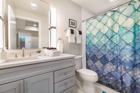 Clean, well-lit bathroom w/ sink & tub — everything you need to refresh.