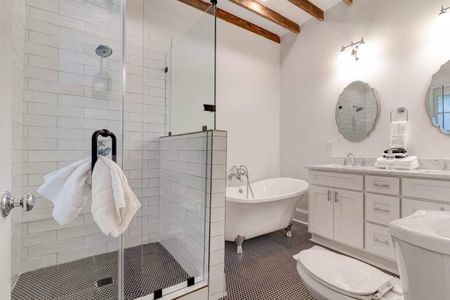 Glass-enclosed shower w/ sleek tile — a refreshing start to any morning.