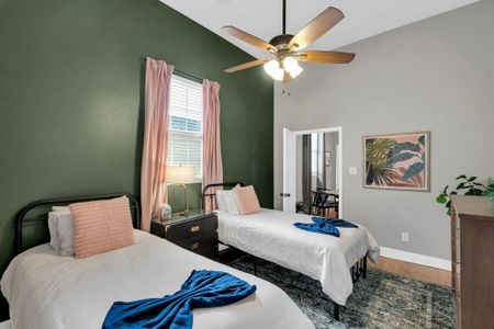 Bright, airy bedroom w/ a bed & soft peach tones — easy comfort for extra guests.