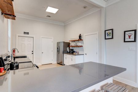 Open kitchen w/ stainless fridge & plenty of cabinet space — everything you need to cook with ease.