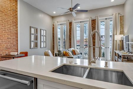 Sunlit kitchen & bar area w/ a sink island — perfect for casual mornings.