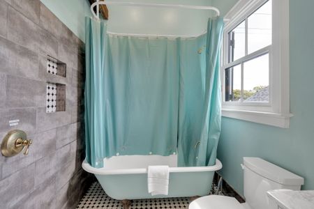 Bright space w/ teal curtains & a light-filled, cheerful energy.