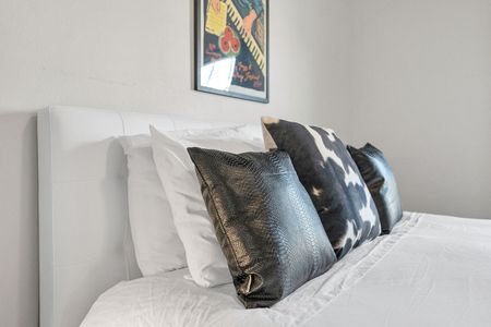 Third bedroom w/ a plush bed & layered pillows for a hotel-like feel.