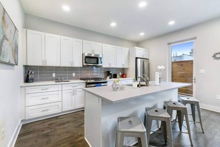 Clean, fully equipped kitchen w/ island seating — ready for your next home-cooked meal.