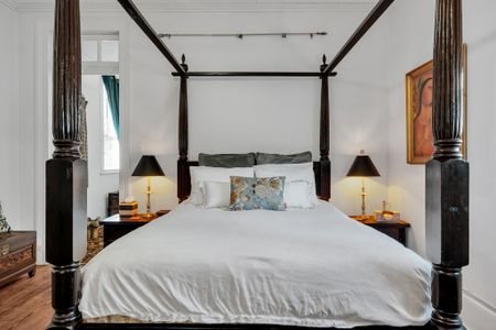 Dreamy four-poster king bed dressed for deep, restful nights.