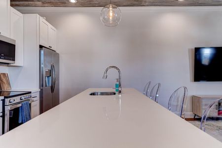 Crisp white kitchen countertops w/ plenty of prep space to cook like at home.