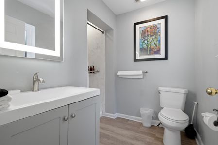 Spacious bathroom w/ soaking tub & tasteful décor to unwind in style.