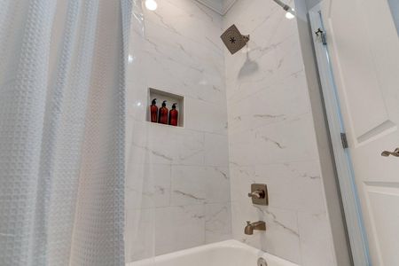 Bright bathroom w/ sink & a relaxing tub to soak away the day.