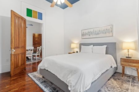 Serene bedroom w/ white bedding & soft light — a peaceful space to recharge.
