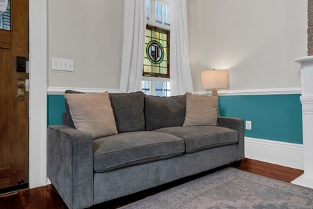 Plush grey sofa in a calm, teal-accented room — unwind & settle in for the night.