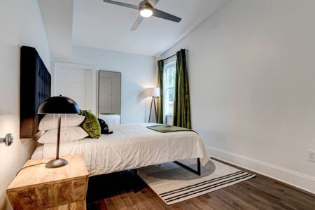 Stylish third bedroom w/ a queen bed, bold accents & warm lighting.