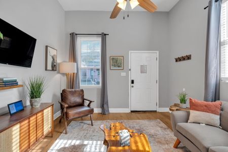 Welcoming entryway w/ a leather chair & soft tones — a relaxed first impression.