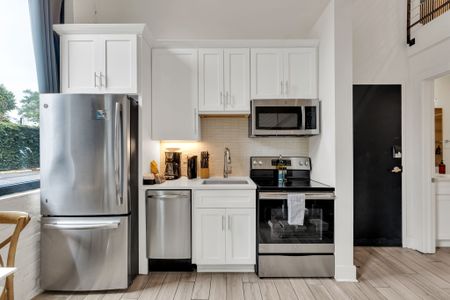Fully equipped kitchen w/ stainless steel appliances, coffee station & sleek finishes.